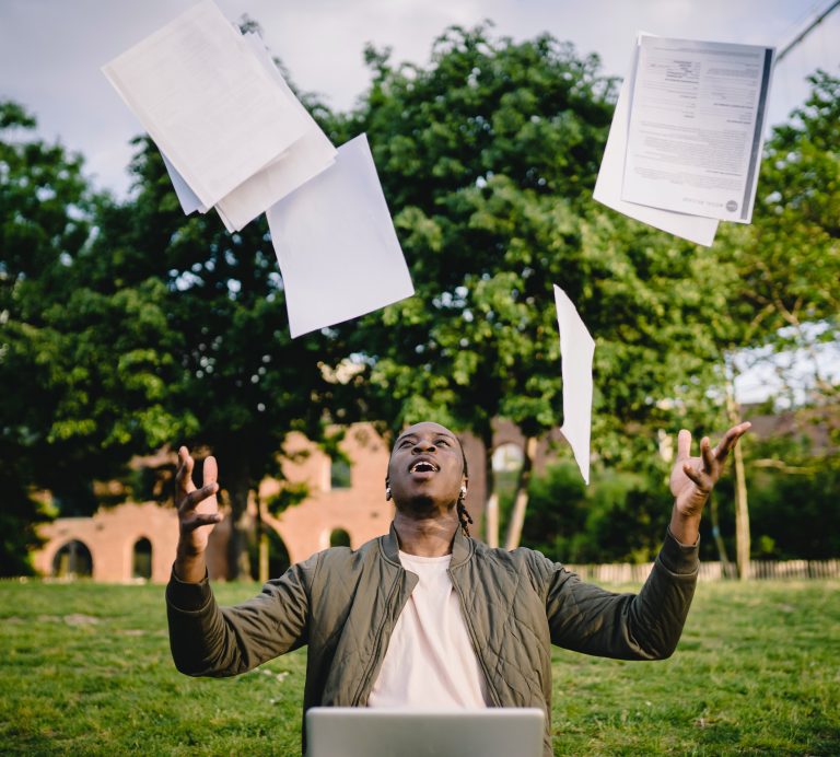 Person throwing resume and career papers into the air